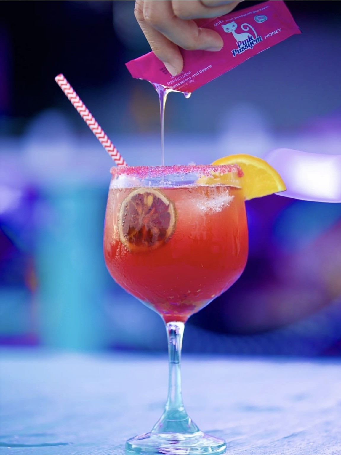 A cocktail being finished with a honey pour at Santorini